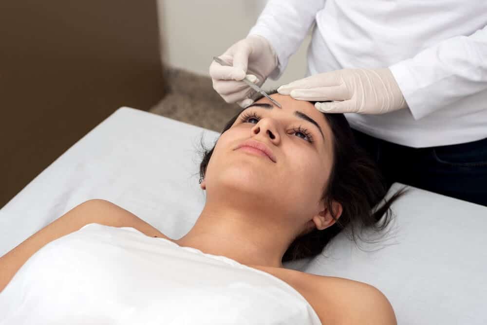 photo of a woman receiving dermaplaning