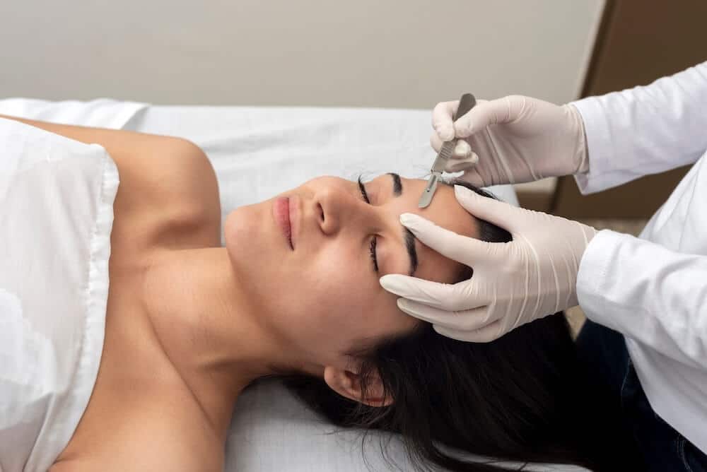 Dermaplaning Face Photo of a woman receiving dermaplaning on the forehead