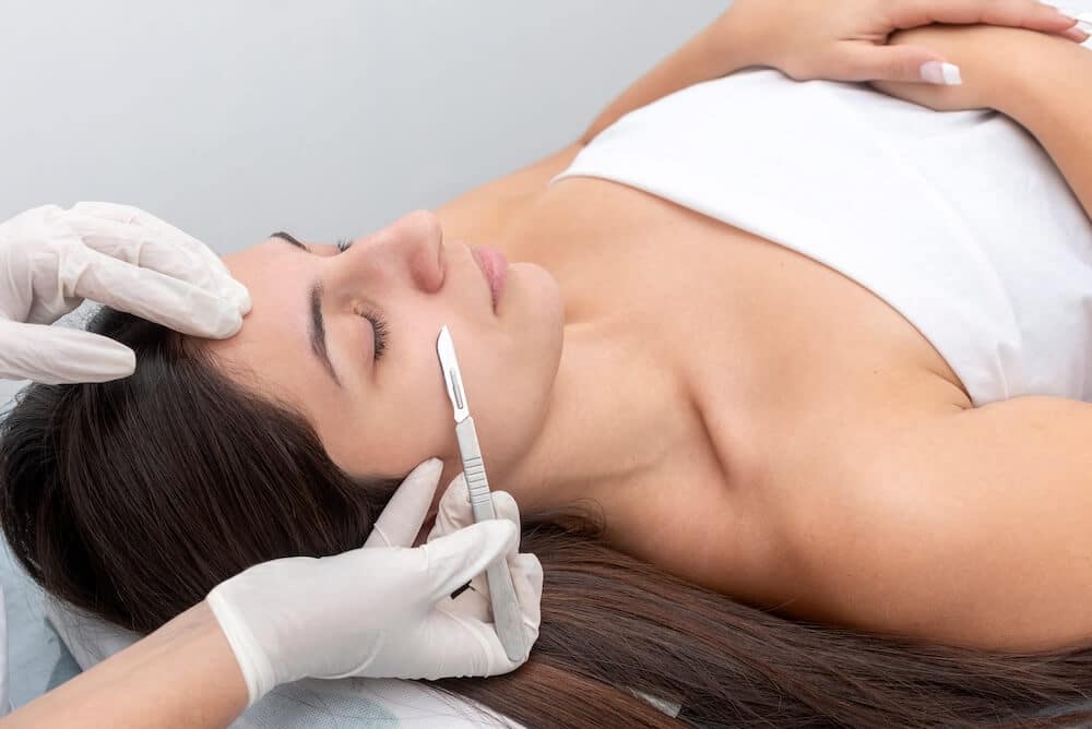 A woman receives dermaplaning