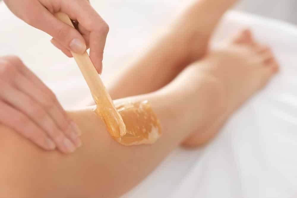 photo of leg wax being applied to a woman's leg